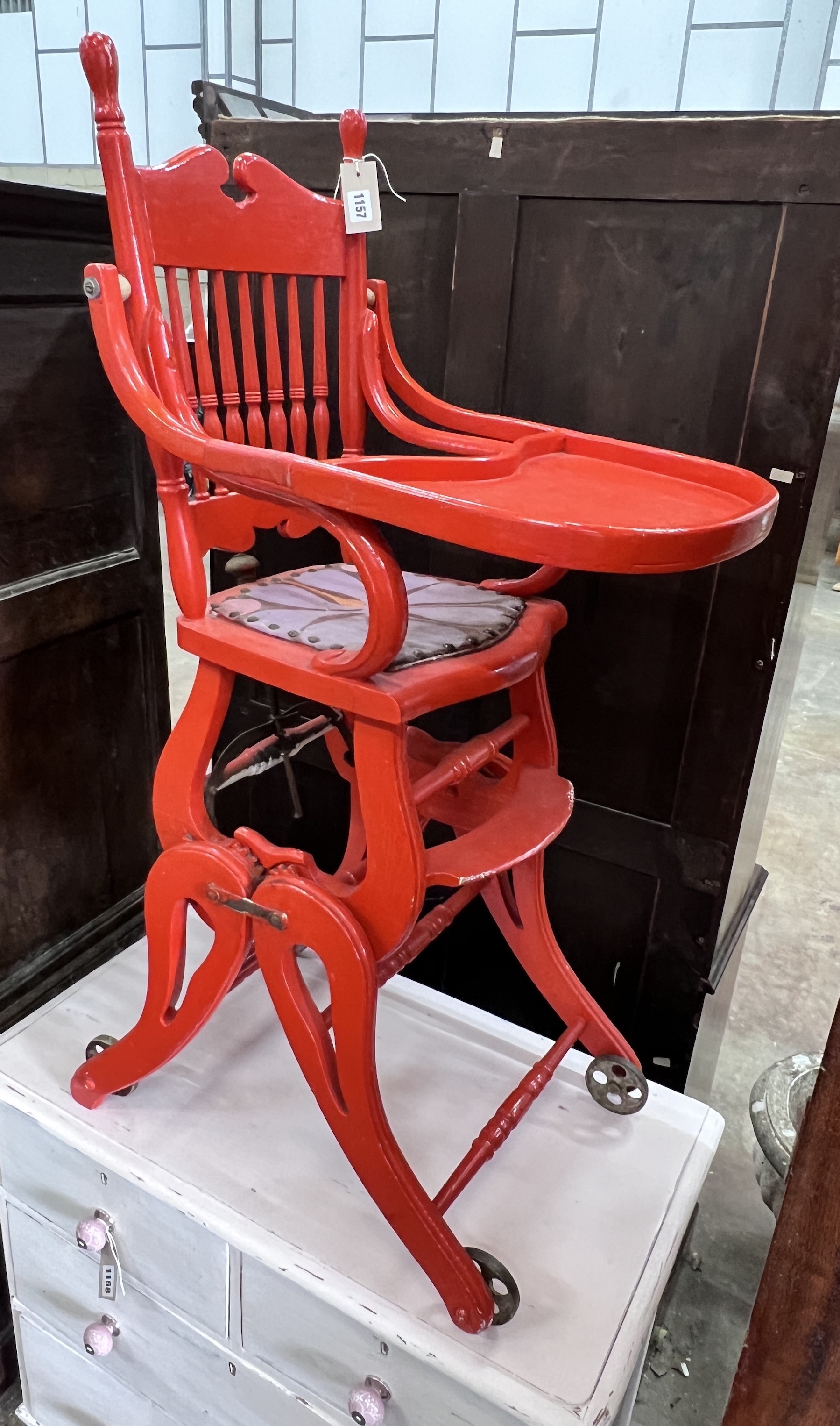 An early 20th century child's metamorphic high chair, later painted red